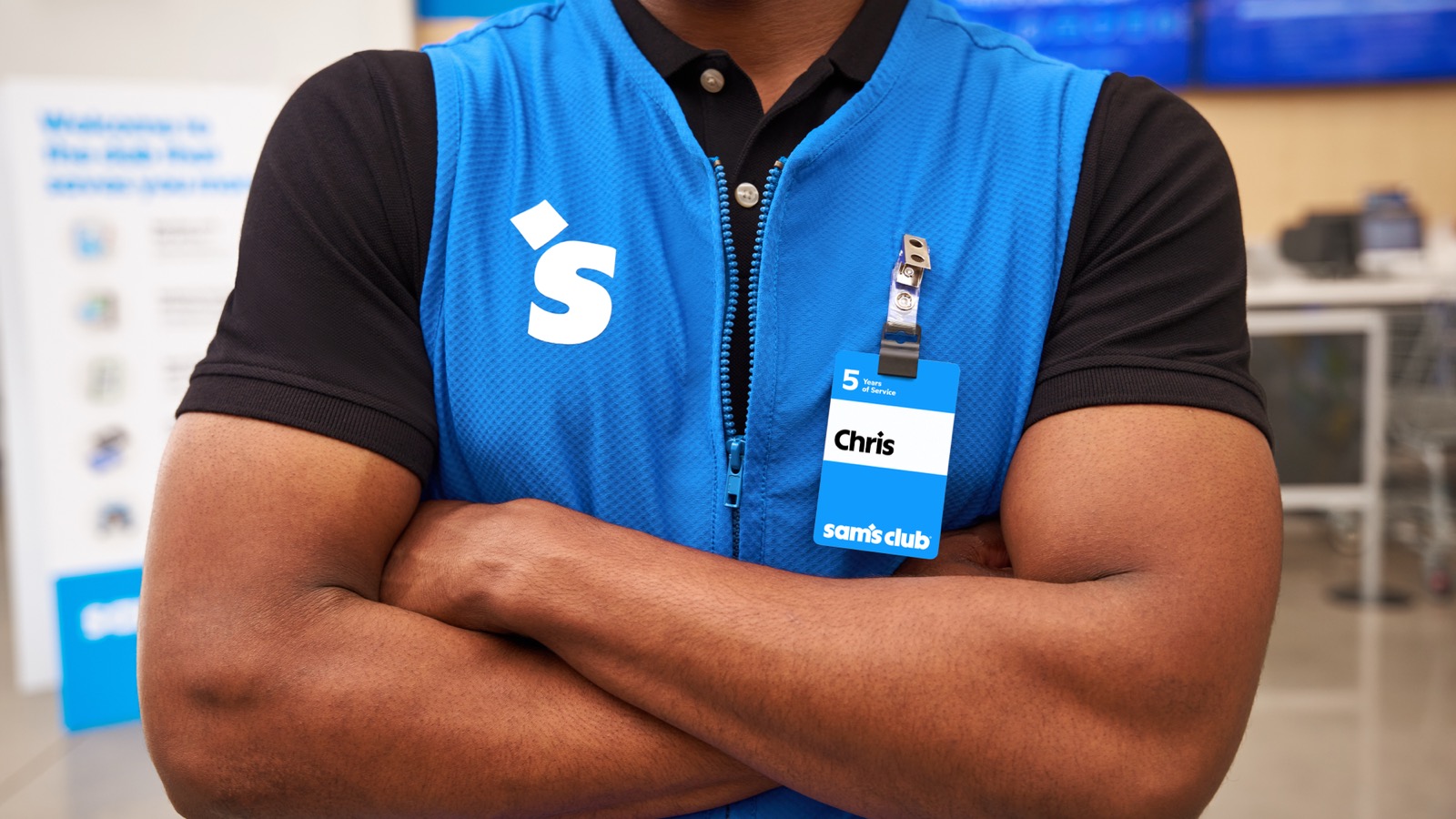 A Sam's Club associate's vest and name badge in the new identity.